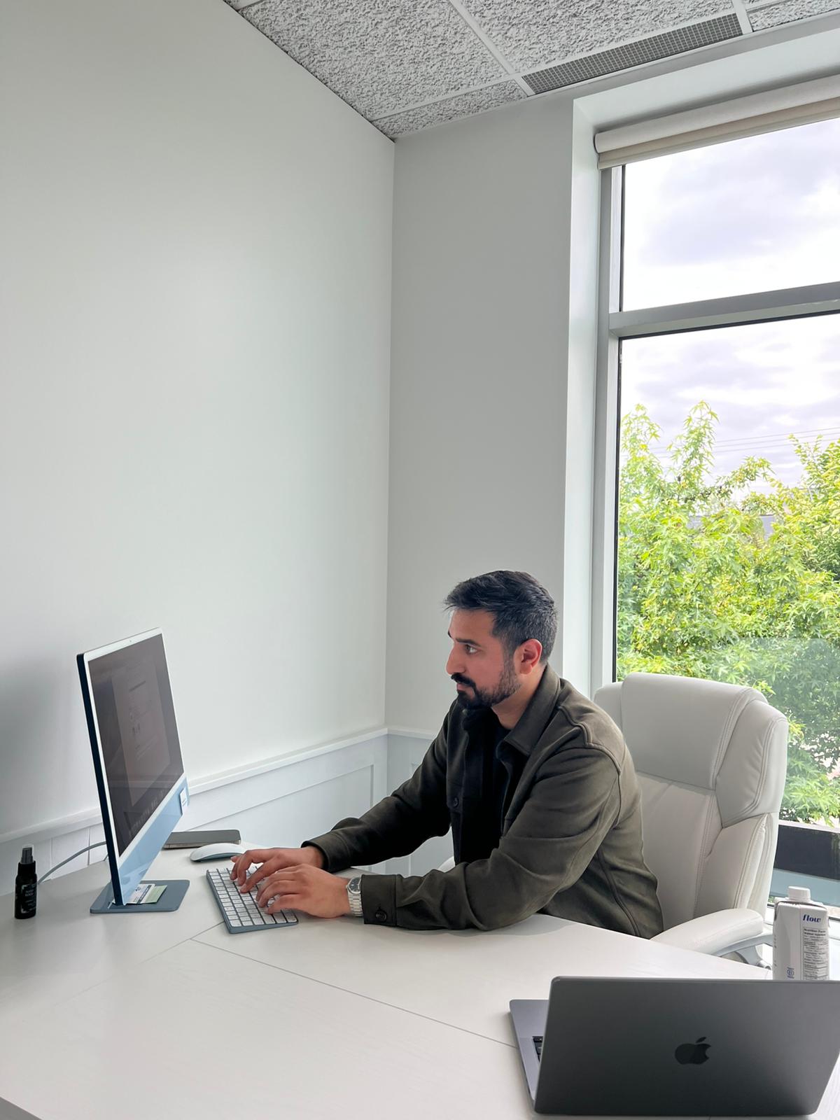 Dr. Randhawa working at his clinic office desk