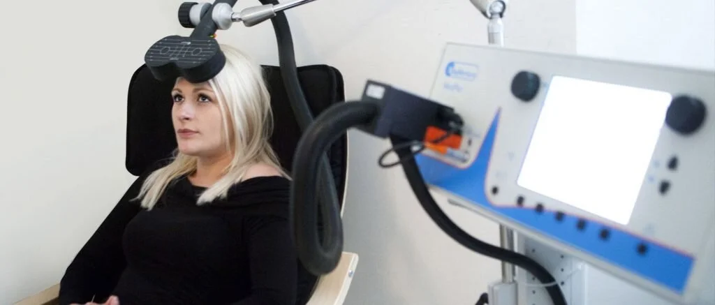 A patient seated for a gentle, non-invasive MeRT® session