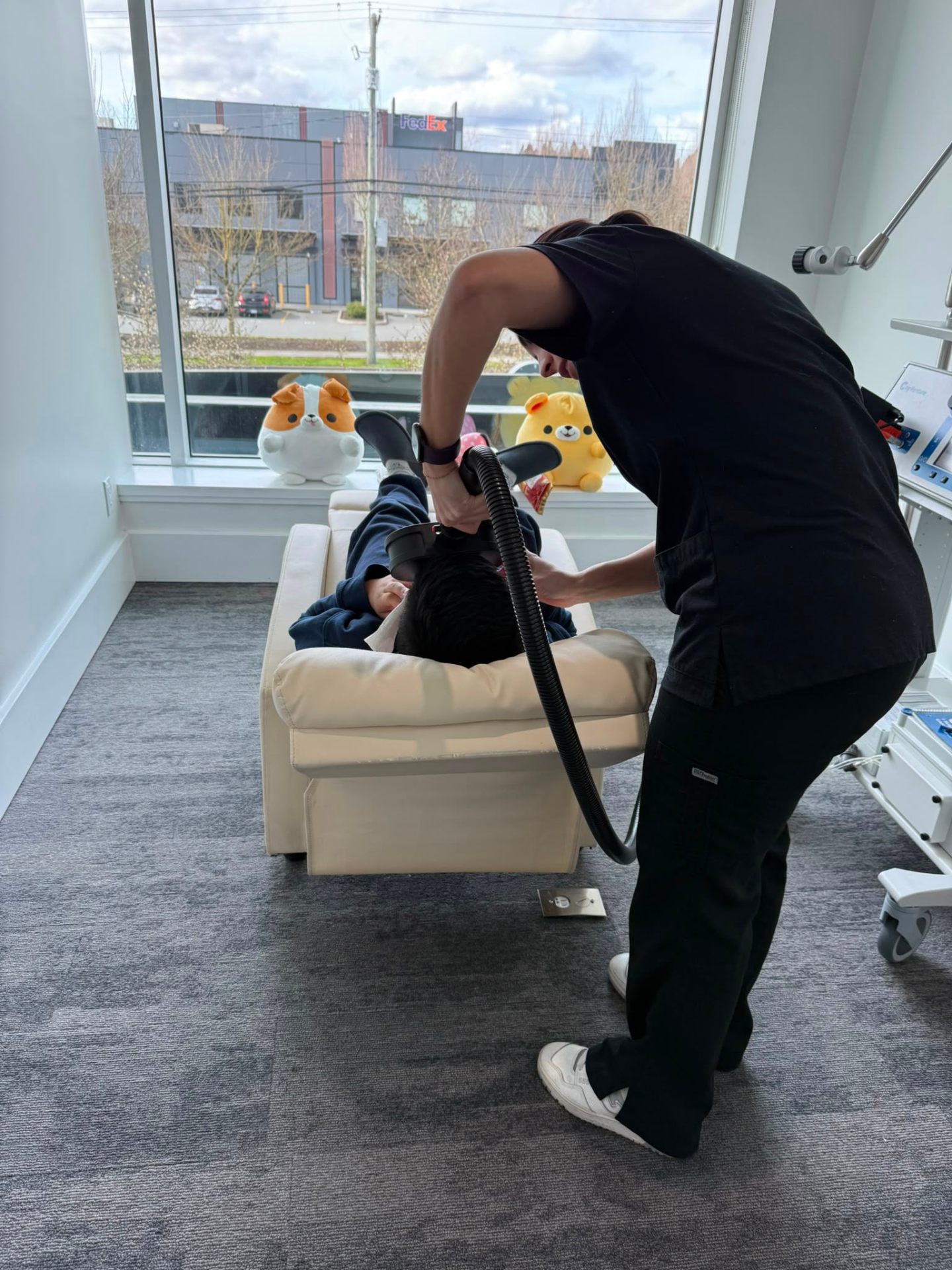 A clinician positioning the MeRT® coil during a gentle treatment session